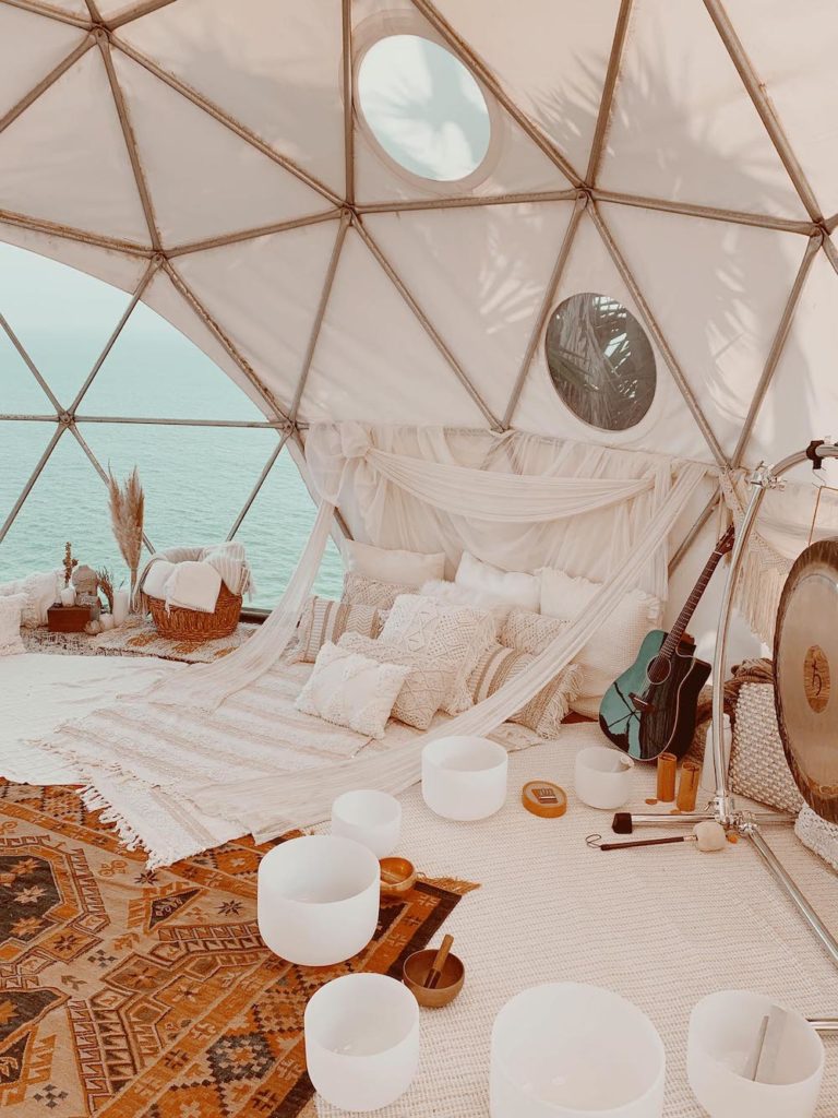 Happy As Annie | 7 Meditation Room from Pinterest You Ned to Copy - and how to get the look! (Malibu meditation space in tent with white and neutral textiles and white sound bath bowls)