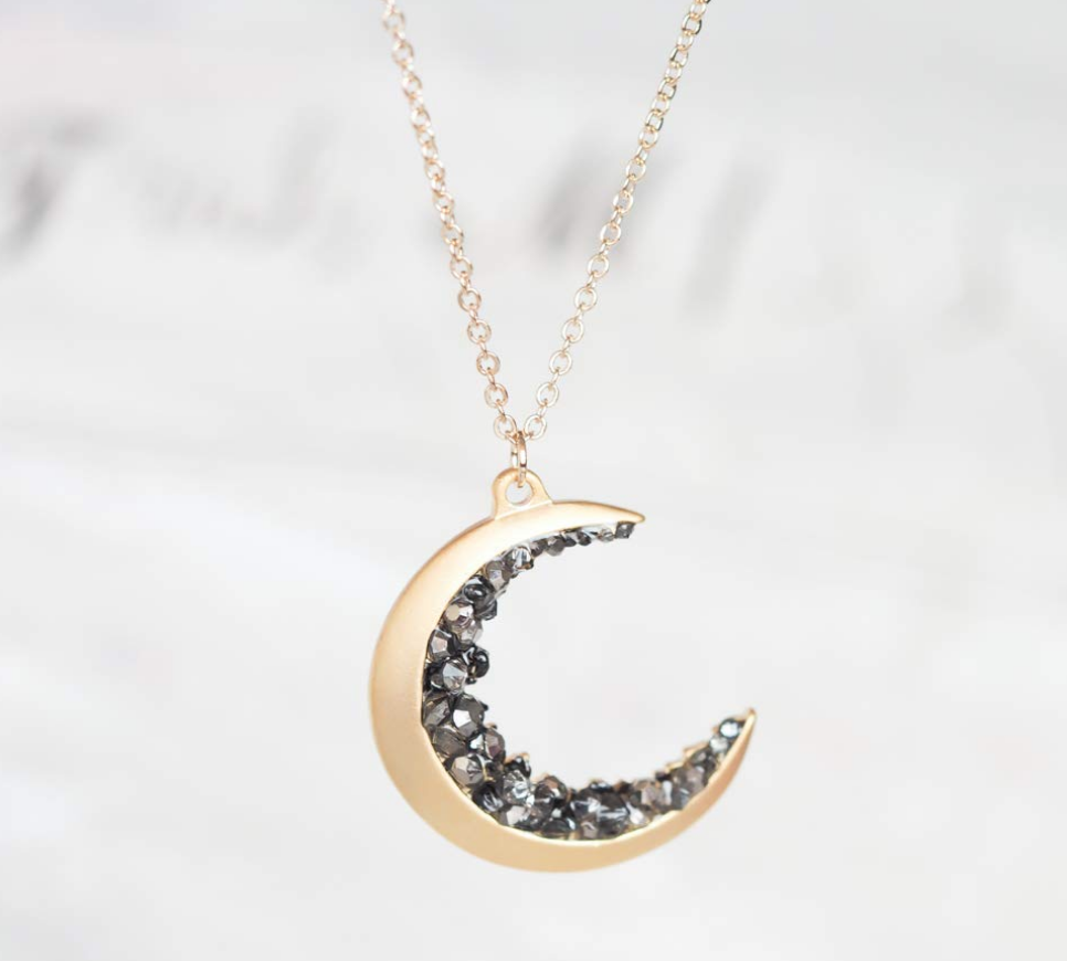 Gold plated crescent moon pendant encrusted with black crystals on The Ultimate Witchy Gift Guide by Happy As Annie