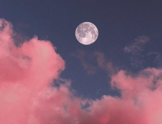 Full moon in blue sky with pink clouds