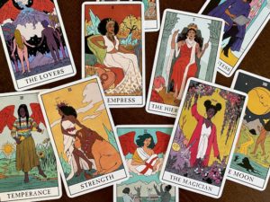 Major Arcana cards jumbled on wooden table, Modern Witch tarot deck