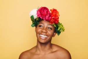 Woman with bare shoulders wearing colorful floral crown