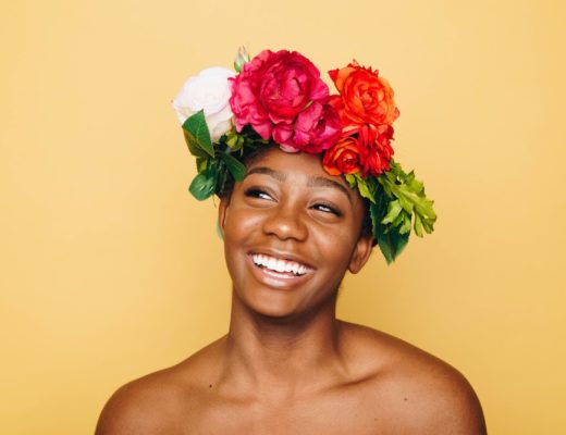 Woman with bare shoulders wearing colorful floral crown