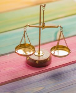 Gold scales on rainbow color painted wooden table