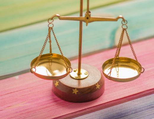 Gold scales on rainbow color painted wooden table